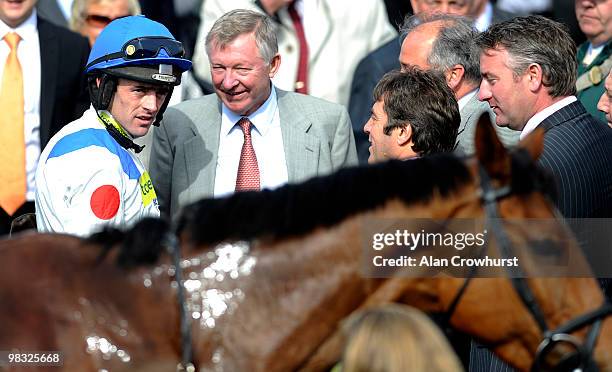 Delighted Sir Alex Ferguson congratulates jockey Ruby Walsh after victory on What A Friend in The totesport Bowl Steeple Chase at Aintree racecourse...
