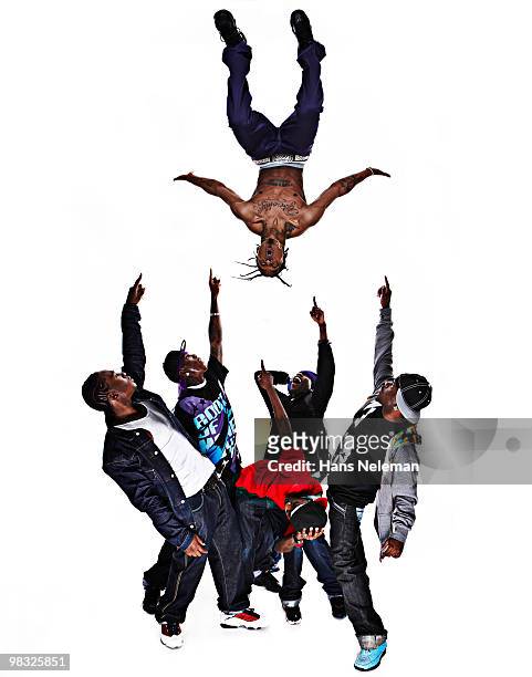 hip hop dancer performing stunt with his friends pointing at him - freestyle dance stock pictures, royalty-free photos & images