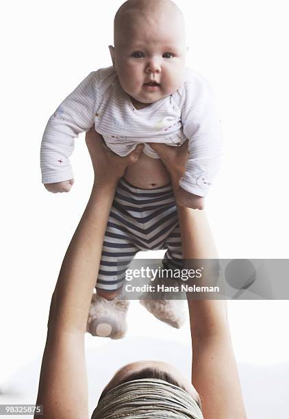 close-up of a woman playing with her son - hans neleman stockfoto's en -beelden