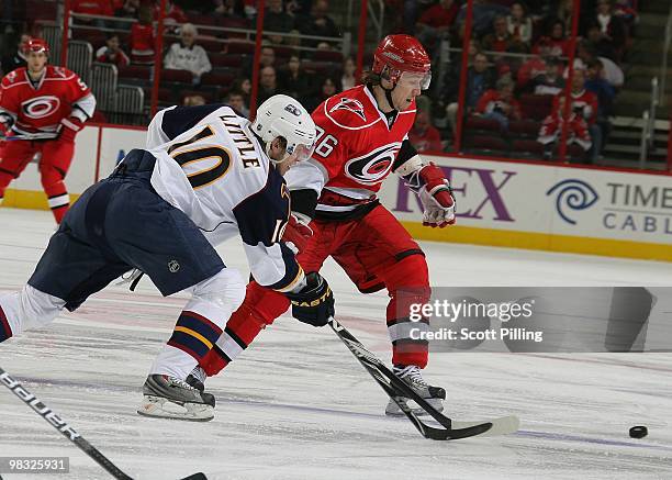 Jussi Jokinen of the Carolina Hurricanes goes for the puck during their NHL game against the Atlanta Thrashers on March 27, 2010 at the RBC Center in...