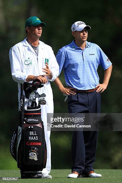 Bill Haas stands next to his caddie Michael Maness on the fifth fairway during the first round of the 2010 Masters Tournament at Augusta National...
