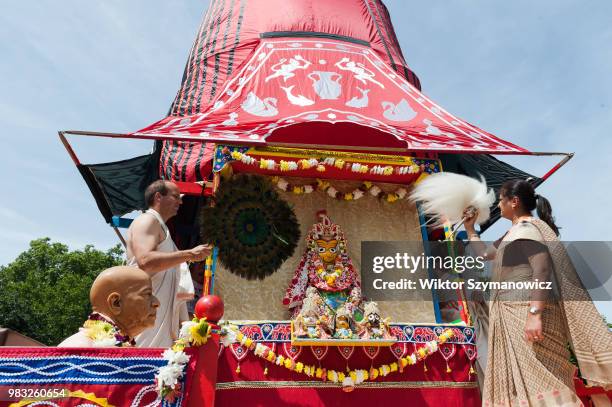 Hare Krishna devotees fan the statue of a deity placed on a wooden chariot ahead of the annual Rathayatra procession through central London....