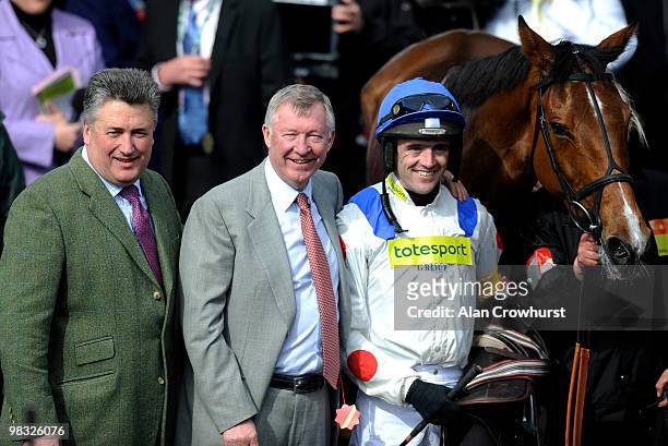 Delighted Sir Alex Ferguson with jockey Ruby Walsh and Trainer Paul Nicholls after victory on What A Friend in The totesport Bowl Steeple Chase at...