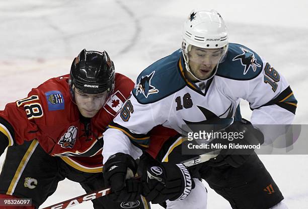 Matt Stajan of the Calgary Flames keeps a close eye on Devon Setoguchi of the San Jose Sharks in the first period of the NHL game on April 6, 2010 at...