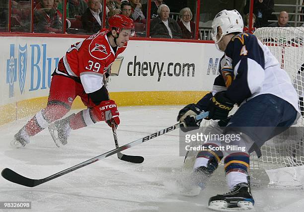Patrick Dwyer of the Carolina Hurricanes skates the puck behind the net of the Atlanta Thrashers during their NHL game on March 27, 2010 at the RBC...