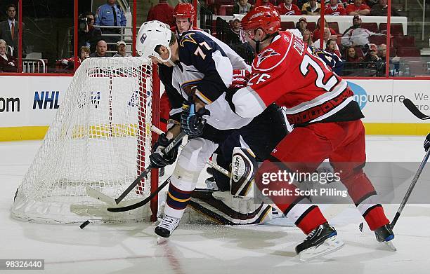 Erik Cole of the Carolina Hurricanes attempts to gain control of the puck against the defense of Pavel Kubina of the Atlanta Thrashers during their...