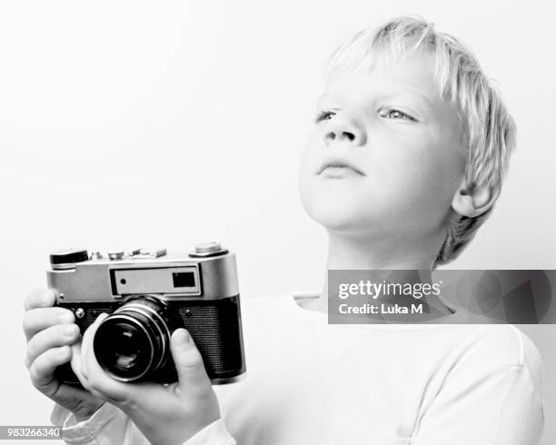 young blonde hair boy holding retro vintage lomo rangefinder cam - lomo camera stock pictures, royalty-free photos & images