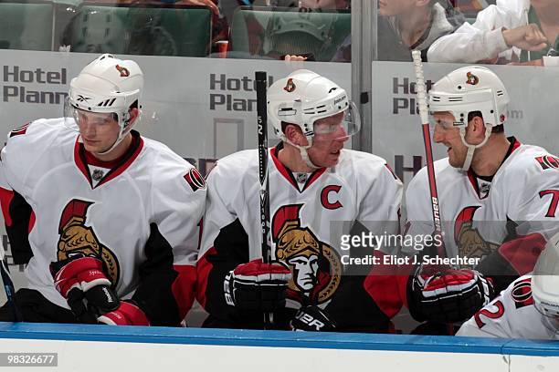 Daniel Alfredsson of the Ottawa Senators chats with teammate Nick Foligno while sitting on the bench between shifts against the Florida Panthers at...