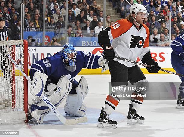 Jonas Gustavsson of the Toronto Maple Leafs defends the goal with Scott Hartnell of the Philadelphia Flyers on the doorstep during the game on April...