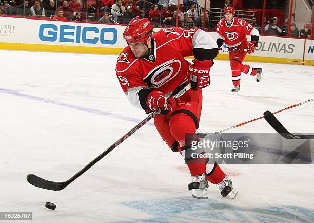 Chad LaRose of the Carolina Hurricanes skates the puck into the defensive zone of the Boston Bruins during their NHL game on March 16, 2010 at the...