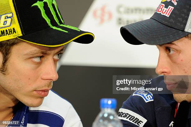 Valentino Rossi of Italy and Fiat Yamaha Team speaks with Andrea Dovizioso of Italy and Repsol Honda Team during a press conference ahead of the...