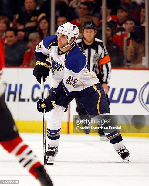 Carlo Colaiacovo of the St. Louis Blues looks to pass the puck against the Chicago Blackhawks at the United Center on April 7, 2010 in Chicago,...