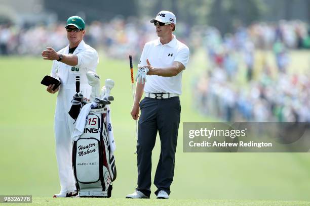 Hunter Mahan talks with his caddie John Wood on the first fairway during the first round of the 2010 Masters Tournament at Augusta National Golf Club...