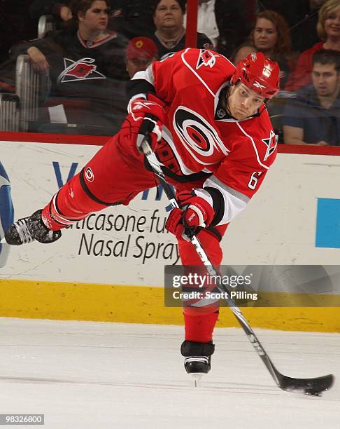 Tim Gleason of the Carolina Hurricanes sends the puck up ice during their NHL game against theBoston Bruins on March 16, 2010 at the RBC Center in...