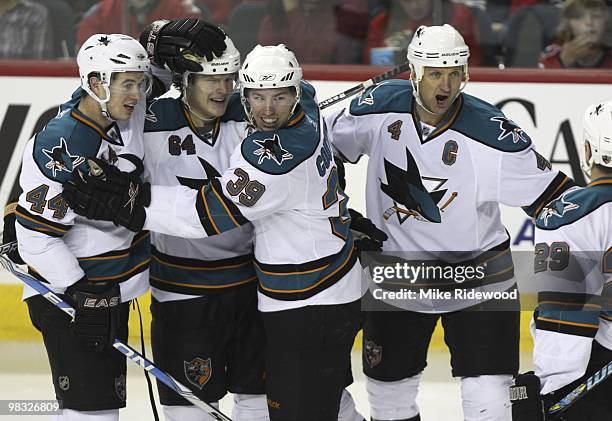 Jamie McGinn of the San Jose Sharks is congratulated by teammate Marc-Edouard Vlasic, Logan Couture and Rob Blake for his goal in the second period...