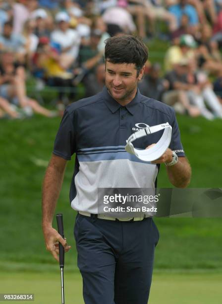Bubba Watson waves to the gallery after making a putt for birdie on the 18th green to win the Travelers Championship at TPC River Highlands on June...