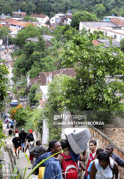 Residents evacuate the Vicoso Jardim shantytown following a landslide on April 08, 2010 in Niteroi, 25 Km northern of Rio de Janeiro, Brazil. Some...