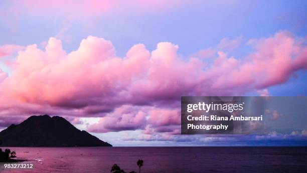 orange smeared clouds in the blue sky - north maluku stock pictures, royalty-free photos & images