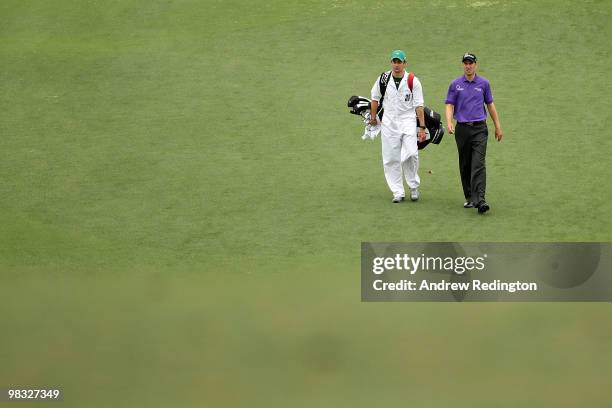 Ross Fisher of England walks with his caddie Adam Marrow down the first fairway during the first round of the 2010 Masters Tournament at Augusta...