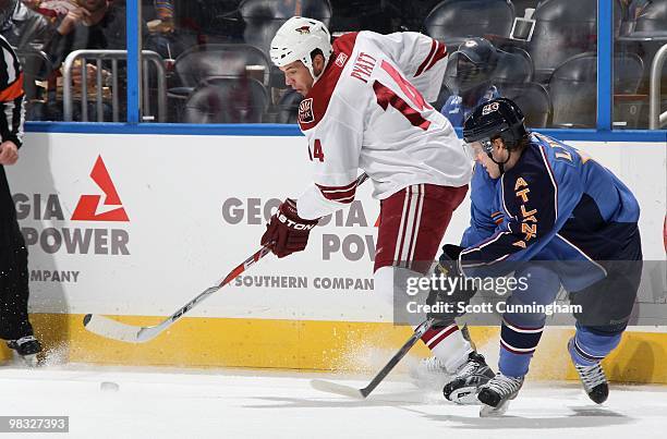 Taylor Pyatt of the Phoenix Coyotes battles the puck against Bryan Little of the Atlanta Thrashers at Philips Arena on March 14, 2010 in Atlanta,...