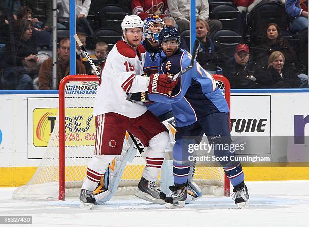 Shane Doan of the Phoenix Coyotes battles for position against Johnny Oduya of the Atlanta Thrashers at Philips Arena on March 14, 2010 in Atlanta,...