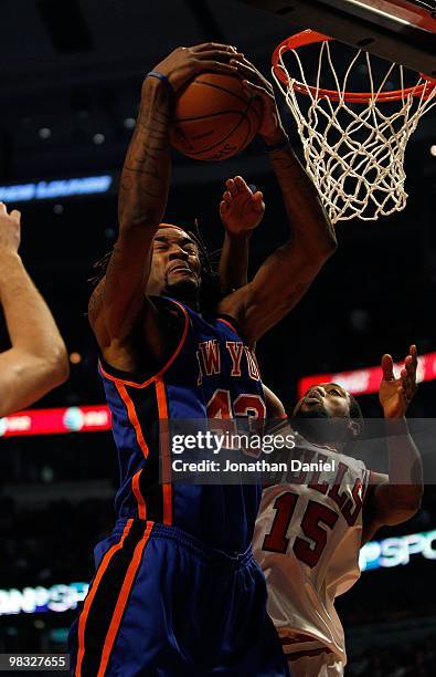 Jordan Hill of the New York Knicks pulls down a rebound against John Salmnons of the Chicago Bulls at the United Center on February 16, 2010 in...