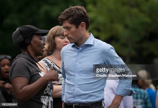 Minneapolis Mayor Jacob Frey speaks with a woman at a vigil for Thurman Blevins on June 24, 2018 in Minneapolis, Minnesota. Blevins was shot and...