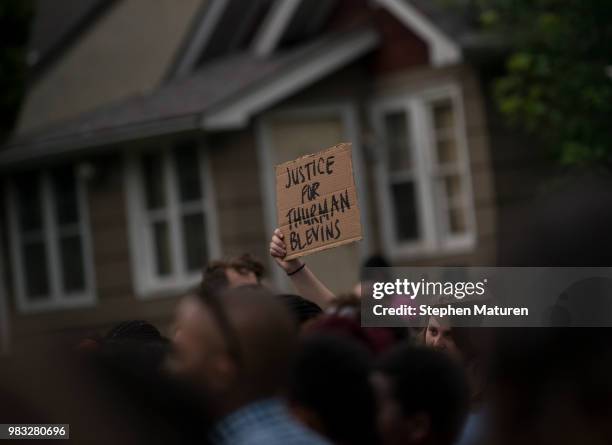 Crowd member holds up a sign at a vigil for Thurman Blevins on June 24, 2018 in Minneapolis, Minnesota. Blevins was shot and killed yesterday after...