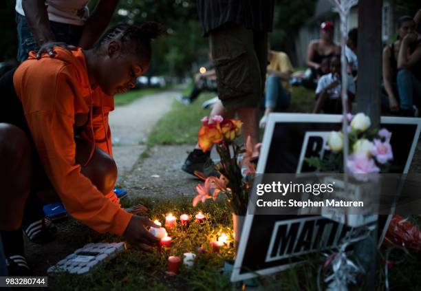 Woman lights candles at a vigil for Thurman Blevins on June 24, 2018 in Minneapolis, Minnesota. Blevins was shot and killed yesterday after an...