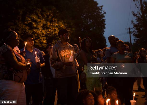 People gathered hold candles at a vigil for Thurman Blevins on June 24, 2018 in Minneapolis, Minnesota. Blevins was shot and killed yesterday after...