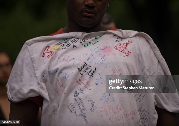 Man holds up a shirt with inscriptions for Thurman Blevins at a vigil on June 24, 2018 in Minneapolis, Minnesota. Blevins was shot and killed...