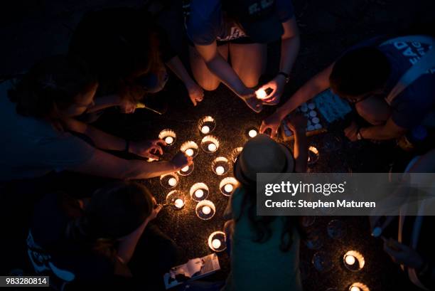 Group lights candles at a vigil for Thurman Blevins on June 24, 2018 in Minneapolis, Minnesota. Blevins was shot and killed yesterday after an...