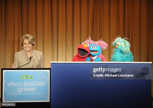 Anchorwoman Katie Couric and Sesame Street Muppets Elmo, Jesse and Rosita address an audience and the press before a special tree planting ceremony...