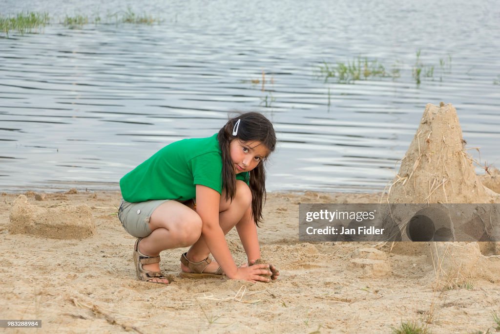 Little girl with sand castle