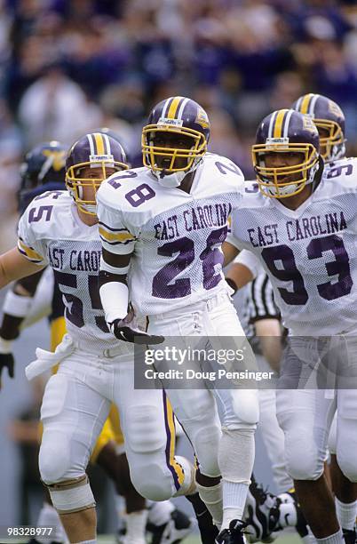 Tabari Wallace of the East Carolina Pirates runs on the field with Jason Shell and Brian Johnson during the game against the West Virginia...