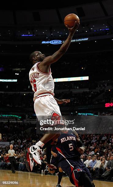 Ronald Murray of the Chicago Bulls goes up for a shot over Josh Smith of the Atlanta Hawks at the United Center on March 1, 2010 in Chicago,...