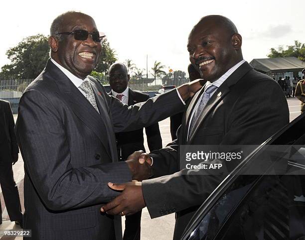 Burundi's President Pierre Nkuruziza shakes hands with Ivory Coast's President Laurent Gbagbo after their meeting at the Presidential Palace in...