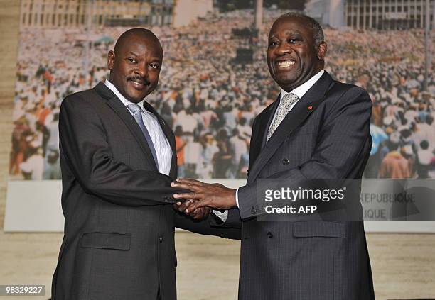 Burundi's President Pierre Nkuruziza shakes hands with Ivory Coast's President Laurent Gbagbo after their meeting at the Presidential Palace in...