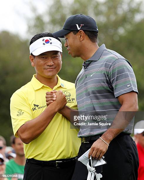 Tiger Woods greets K.J. Choi of South Korea on the first tee during the first round of the 2010 Masters Tournament at Augusta National Golf Club on...