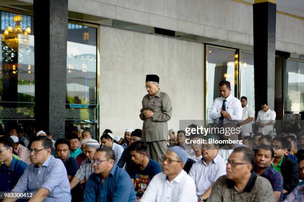 Mahathir Mohamad, Malaysias prime minister, center, performs the Sunnah prayer before the congregational Friday prayer at the National Mosque in...