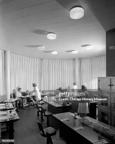 Interior view of the restaurant at the Burlington railroad station, with waitresses serving passengers, Iowa, 1944.