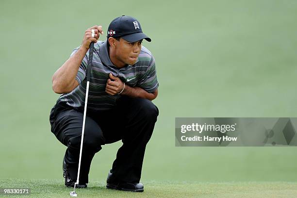 Tiger Woods lines up his putt on the second hole during the first round of the 2010 Masters Tournament at Augusta National Golf Club on April 8, 2010...