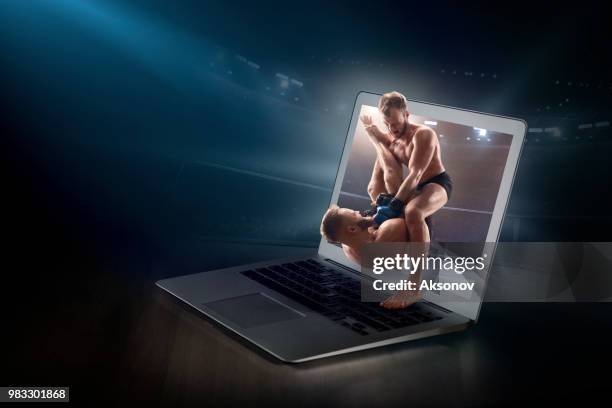 mixed martial arts on laptop. live broadcast - aksonov stock pictures, royalty-free photos & images