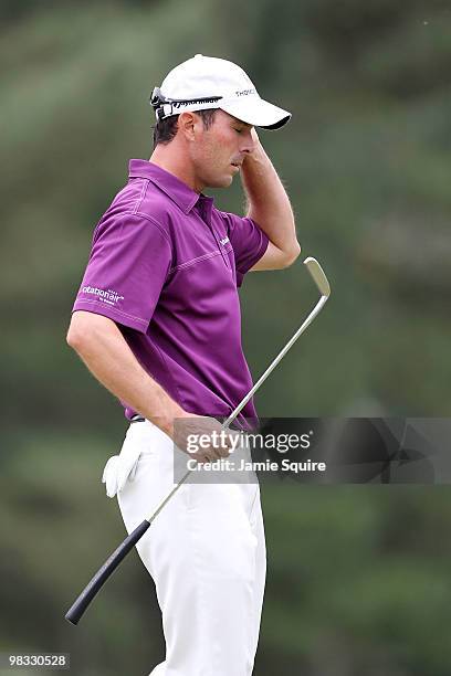 Mike Weir of Canada reacts on the 18th hole during the first round of the 2010 Masters Tournament at Augusta National Golf Club on April 8, 2010 in...