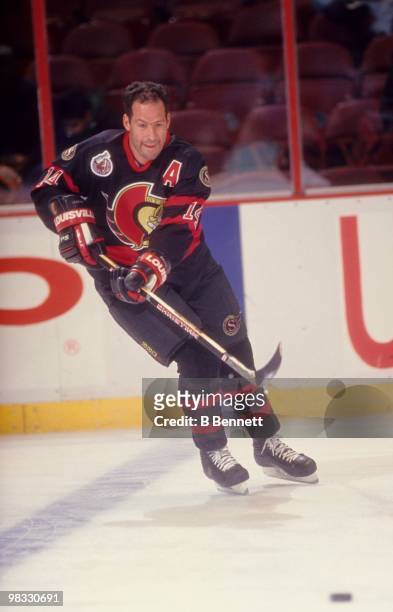 Brad Marsh of the Ottawa Senators passes the puck during an NHL game against the New York Islanders circa 1992-93 at the Nassau Coliseum in...