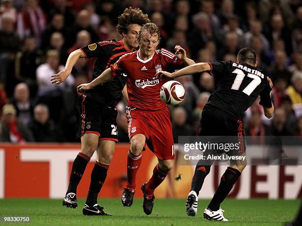 Dirk Kuyt of Liverpool competes for the ball with David Luiz and Carlos Martins of Benfica during the UEFA Europa League Quarter Final second leg...