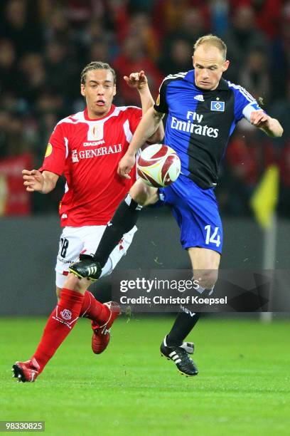 Axel Witsel of Liege challenges David Jarolim of Hamburg during the UEFA Europa League quarter final second leg match between Standard Liege and...
