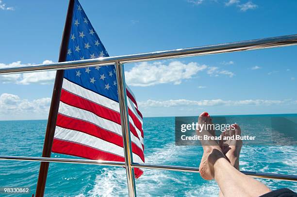 woman relaxing on a yacht at sea - marsh harbour - fotografias e filmes do acervo