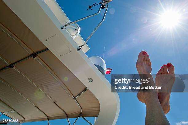 woman relaxing on a yacht - abaco islands stockfoto's en -beelden