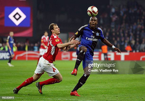 Milan Jovanovic of Liege and Guy Demel of Hamburg battle for the ball during the UEFA Europa League quarter final second leg match between Standard...